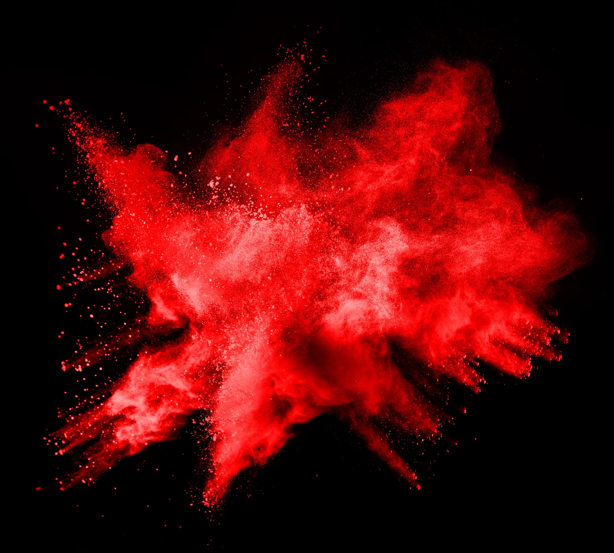 abstract red powder explosion on black background.abstract red powder splatted on black background. Freeze motion of red powder exploding.